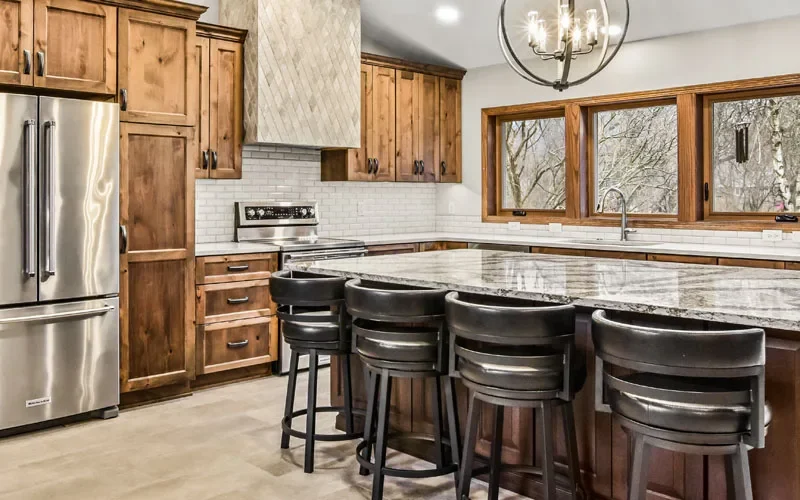 A modern kitchen featuring a large island and sleek stainless steel appliances.
