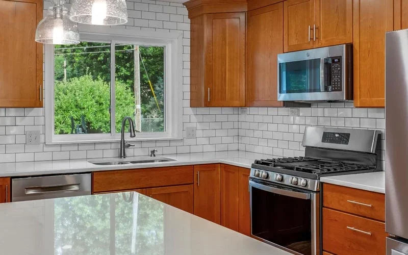A modern kitchen featuring stainless steel appliances and warm wood cabinets, creating a stylish and functional space
