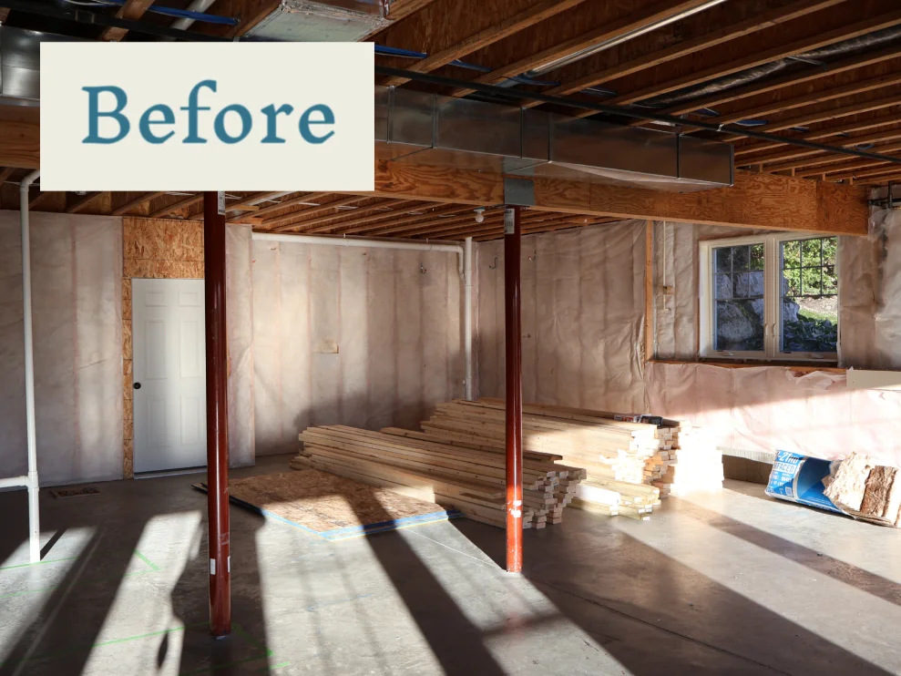 Basement before remodel with exposed framing and insulation