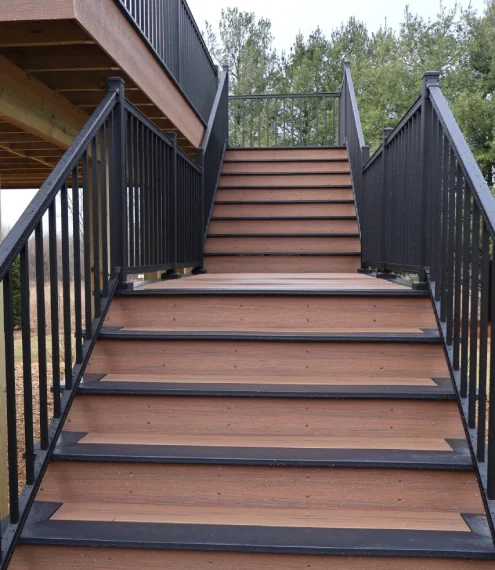 Outdoor deck stairs with composite decking and metal railings
